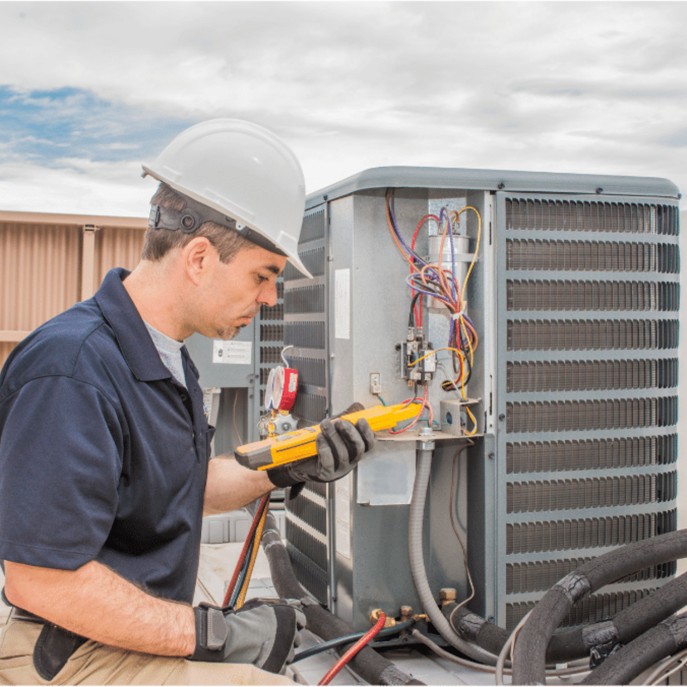 St Thomas Heating & Cooling HVAC technician servicing a system