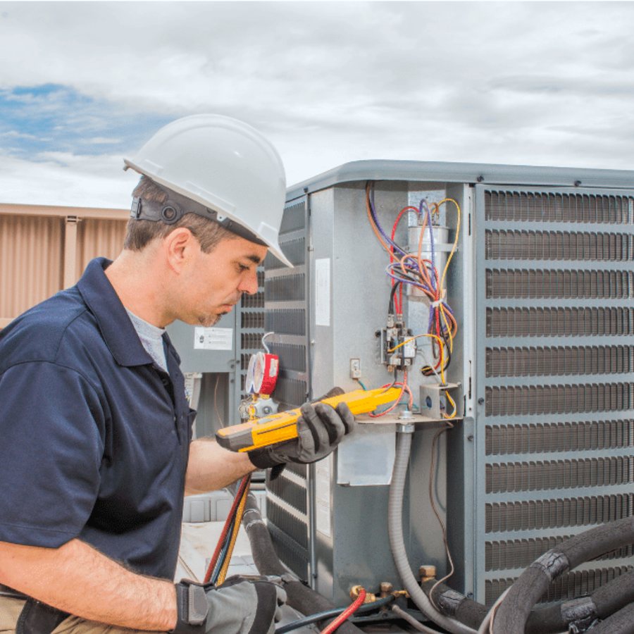 St Thomas Heating & Cooling HVAC technician servicing a system